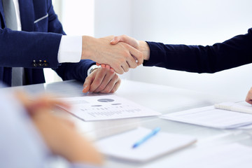 Group of business people or lawyers shaking hands finishing up a meeting , close-up. Success at negotiation and handshake concepts