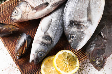 Board with fresh seafood on table