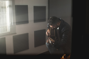 Young man with a classical guitar indoors. Concept Musician guitarist