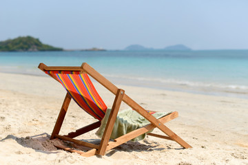 Fototapeta na wymiar Chaise lounge on the tropical beach at sunny summer day. Travel vacation relax concept.