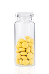 Yellow pills with glass bottle