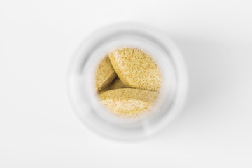 Medical pills in a glass container isolated