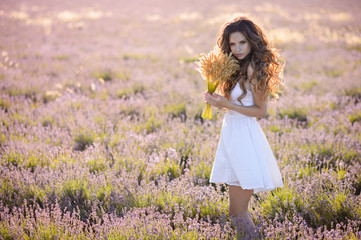 Fototapeta na wymiar Woman in amazing dress walk on the lavender field.