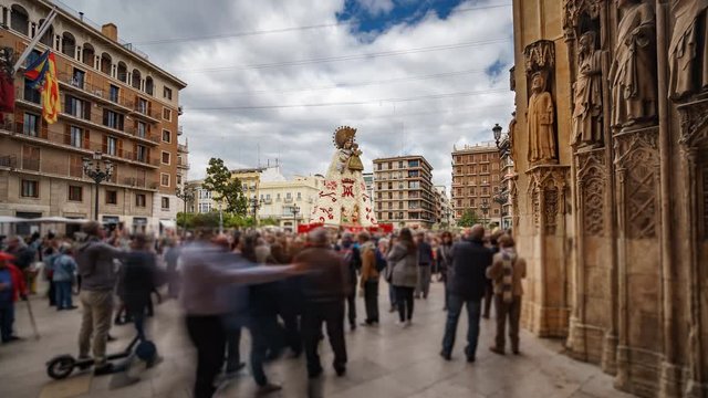 Blurred people visit virgin plaza in Valencia from cathedral, time lapse