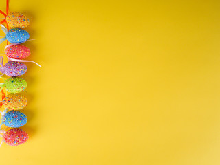 Easter holiday background. coloured decorated easter eggs on a bright yellow background.