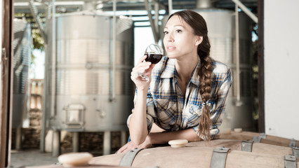 woman with glass of wine posing on the winery of spain