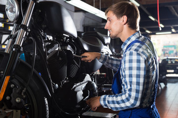Fototapeta na wymiar young male mechanic working in auto repair shop