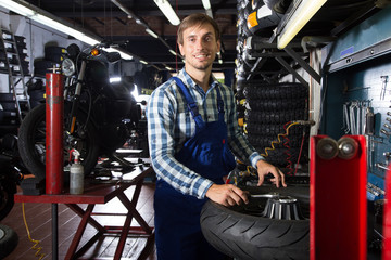 young male mechanic working in auto repair shop