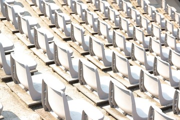 Empty white stadium stand rows with sunlight
