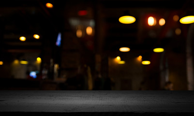 blurred background of bar and dark brown desk space of retro wood