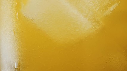 Macro shot in slow motion of Orange soda and ice in a glass background - Powered by Adobe