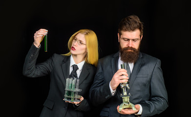 Science. Chemistry. Test tubes. Success. Education. Biology. Woman with chemical test tubes. Bearded man with microscope. Laboratory. Experiment. Progressive school.