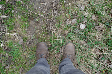 View of dirty shoes on grass