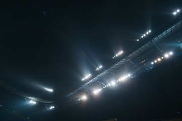 Stadium lights against dark night sky background. Soccer match lights. - 257653341