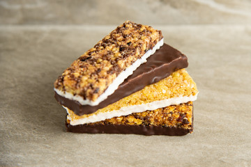 Various muesli bars on marble stone background