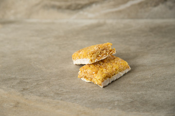 Muesli and cereal bar on marble stone background
