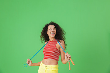 Image of caucasian woman 20s wearing summer clothes working out and doing exercises with jumping...
