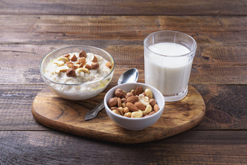 oatmeal with nuts and glass of milk for Breakfast on wooden background