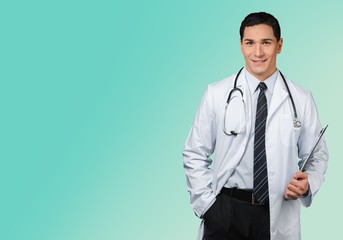 Attractive young female doctor with blurred hospital interior on background