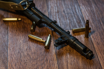 Machine gun lying on the ground with shells