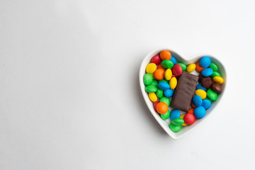 A bowl of multicolor chocolate candies