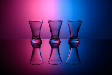 three empty shots on pink and blue background