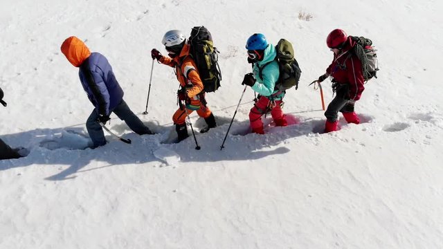 the span of the camera shows as one long line going travelers. They have a lot of equipment, but the path is not given to them easily. they go astray, and stumble, but continue to plot a route through