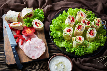 sliced sandwich wraps with ham and veggies
