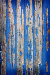peeling blue paint on wooden door or fence
