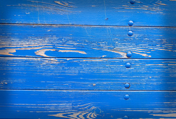 peeling blue paint on hull of old ship