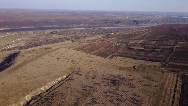 Bird Eye View of the Fields and Agricultural Parcel. River and small village. Moldova republic of. Aerial Views.