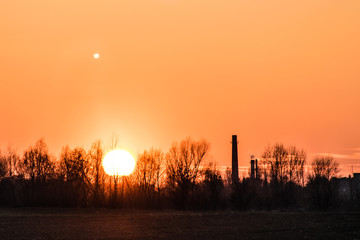 sunset over the industrial zone, moon.