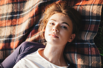 Top view of a lovely young teenage girl laying on a blanket