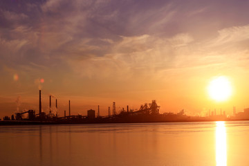 A silhouette of a chemical plant in the setting sun