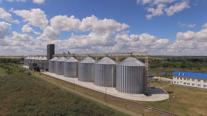 Grain bins and cloudy sky.