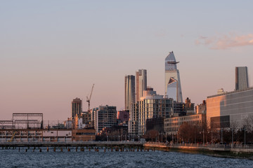 Group of buildings and skyscrapers of Hudson Yards view from pier 26 at sunset in TriBeca District...