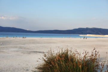 Beautiful blue crater Lake Salda (Salda Golu) in Burdur province ,Turkey with endless white sandy beach at sunset / blue lake background 