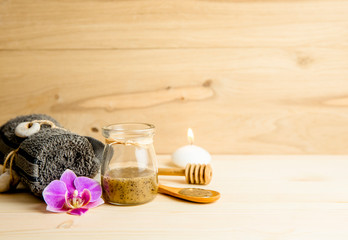 Scrubbing honey and coffee mixture on body in hot sauna helps open the pores and renew, rejuvenate the skin on body. Sauna treatment concept. Flat lay view of sauna honey.
