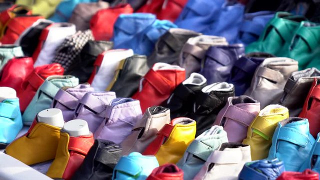 handmade colorful children's shoes stand at flea market