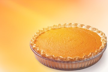 Home made pumpkin pie on white background.