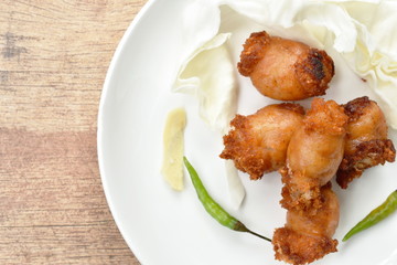 fried sour Thai sausage stuffed minced pork and glass noodles on plate