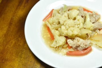 stir fried cauliflower with carrot and pork on plate