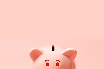 Piggy bank on living coral background. Commercial concept. Commercial concept.Top view point, flat...