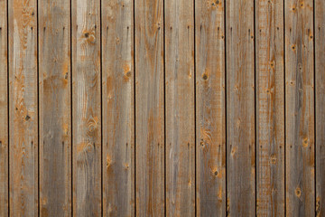 gray yellow fence of dry boards with nails. rough surface texture