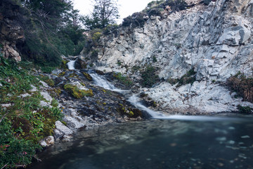 Long exposure shot of a litle creek descending from the mountain in Patagonia
