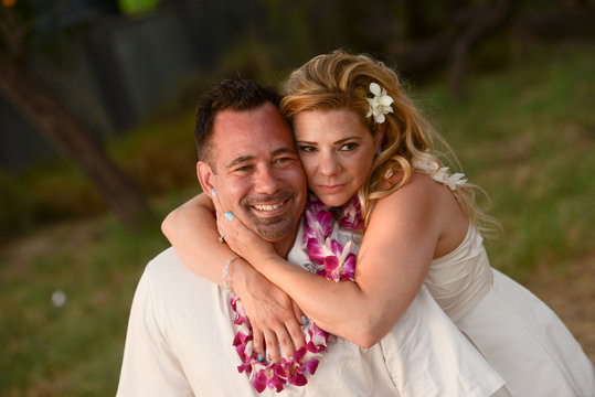 Couple in love embracing during vow renewal ceremony in Hawaii 