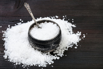 Fototapeta na wymiar silver salt cellar with coarse Sea Salt on table