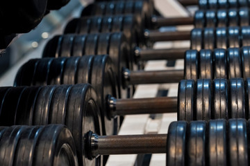 Fototapeta na wymiar Close up image of chrome dumbbells in gym