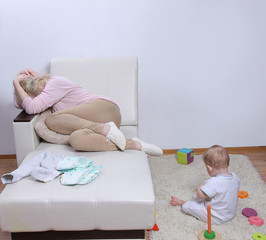 woman sits with her child, postpartum depression