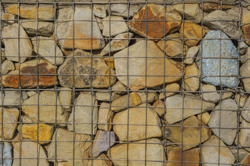 Art Rough Stylized textural banner with space for text. Metal mesh holds many stones.